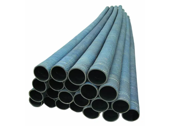 Black water suction and discharge hoses stacked on a white background